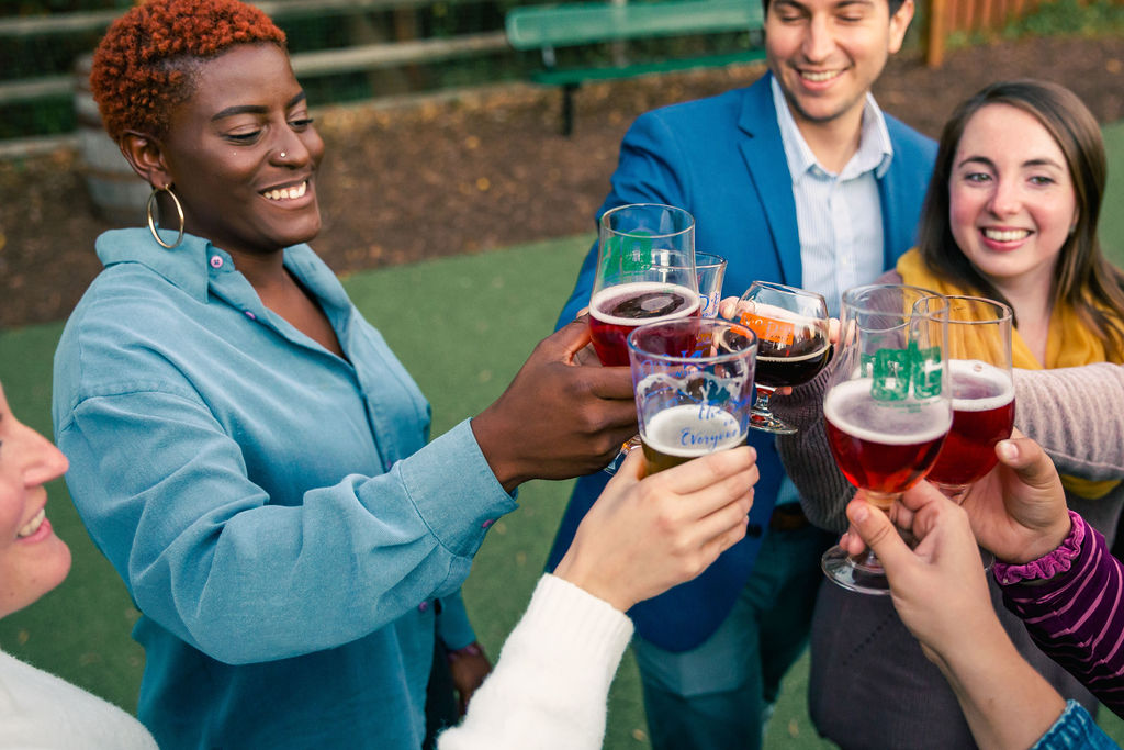 Guests cheers beers outside of a taproom