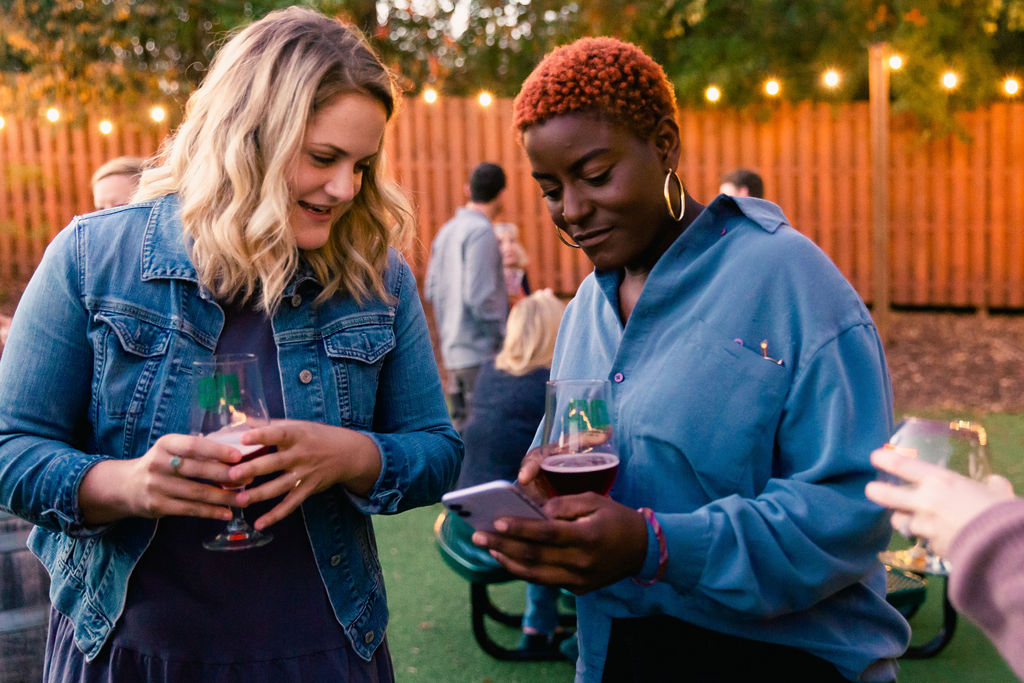 One guest shows their friend how easy it is to order using their own smartphone