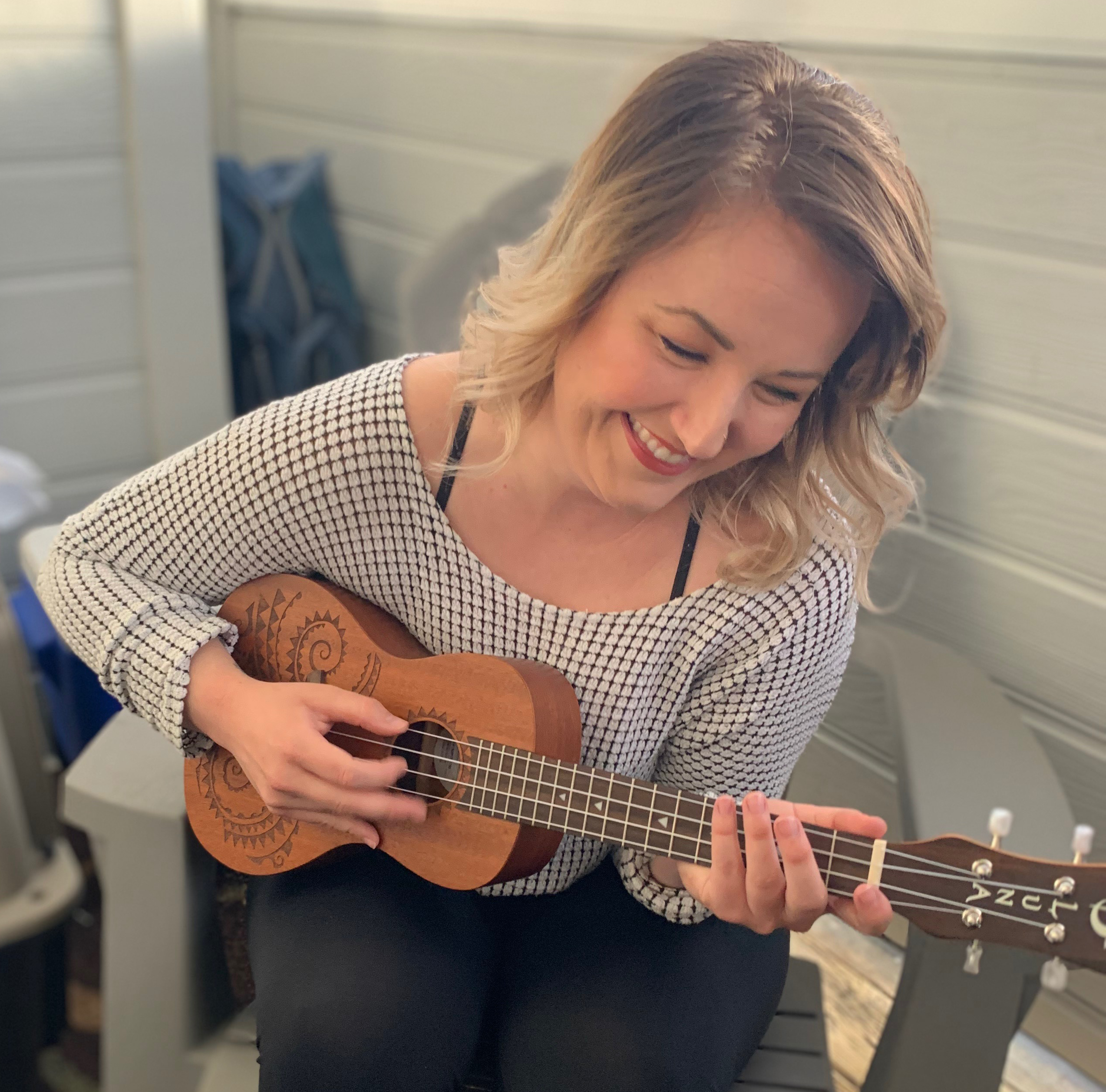 Arryved product support specialists Olyvia Beyette playing the ukulele