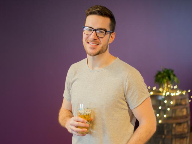 Nate Culbertson holding a pint glass