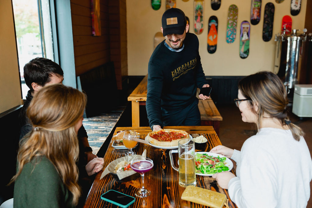 Server serving food and drinks to table