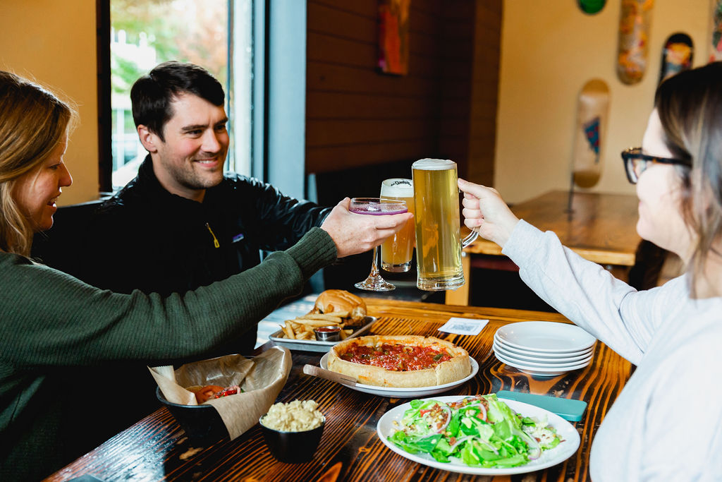 Three people cheers before eating their food