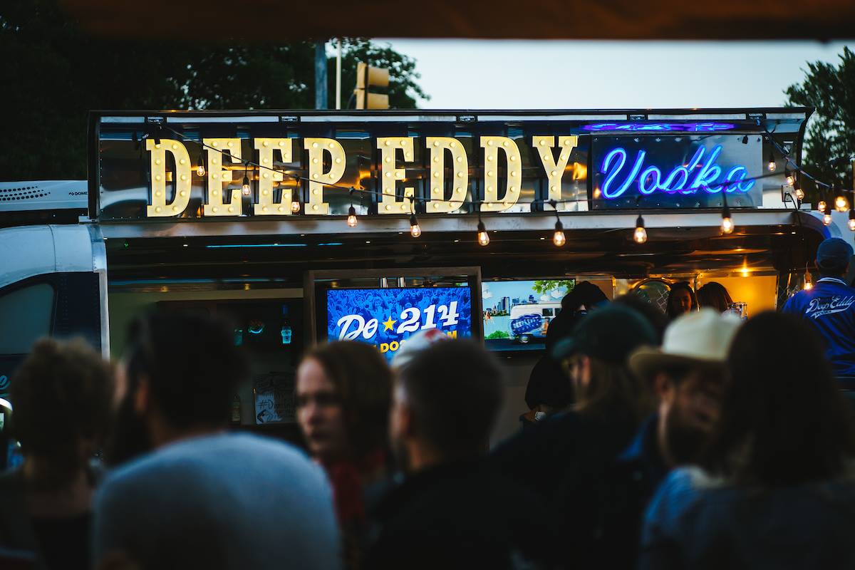 Close up shot of the light-up Deep Eddy Vodka sign outside their festival trailer.